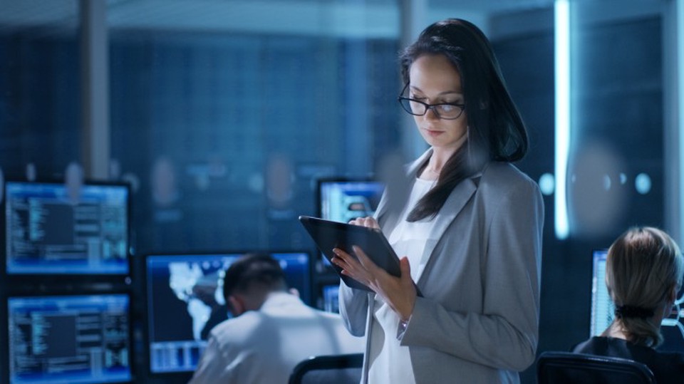 A cybersecurity professional uses a tablet.